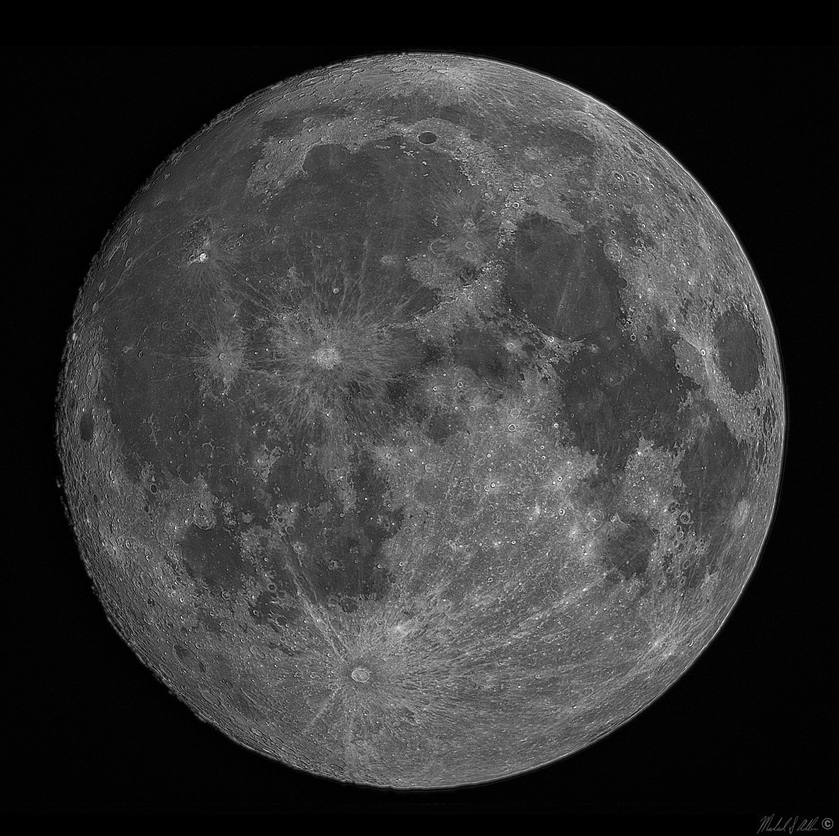 The near-full moon, deep orange during a lunar eclipse